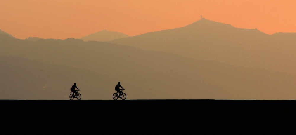 Man on bicycle on top of a mountain